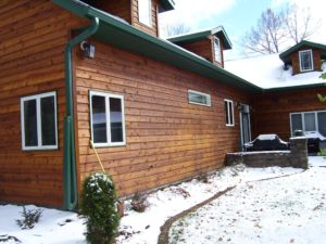 green seamless gutters on cabin style home