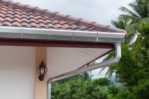 leaf guard gutter roof on residential building house on rainy day