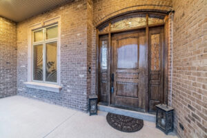 Beautiful facade of a house with front door and window against stone brick wall