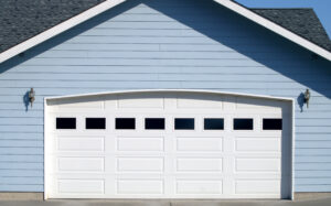 Arched garage door of a house with metal siding
